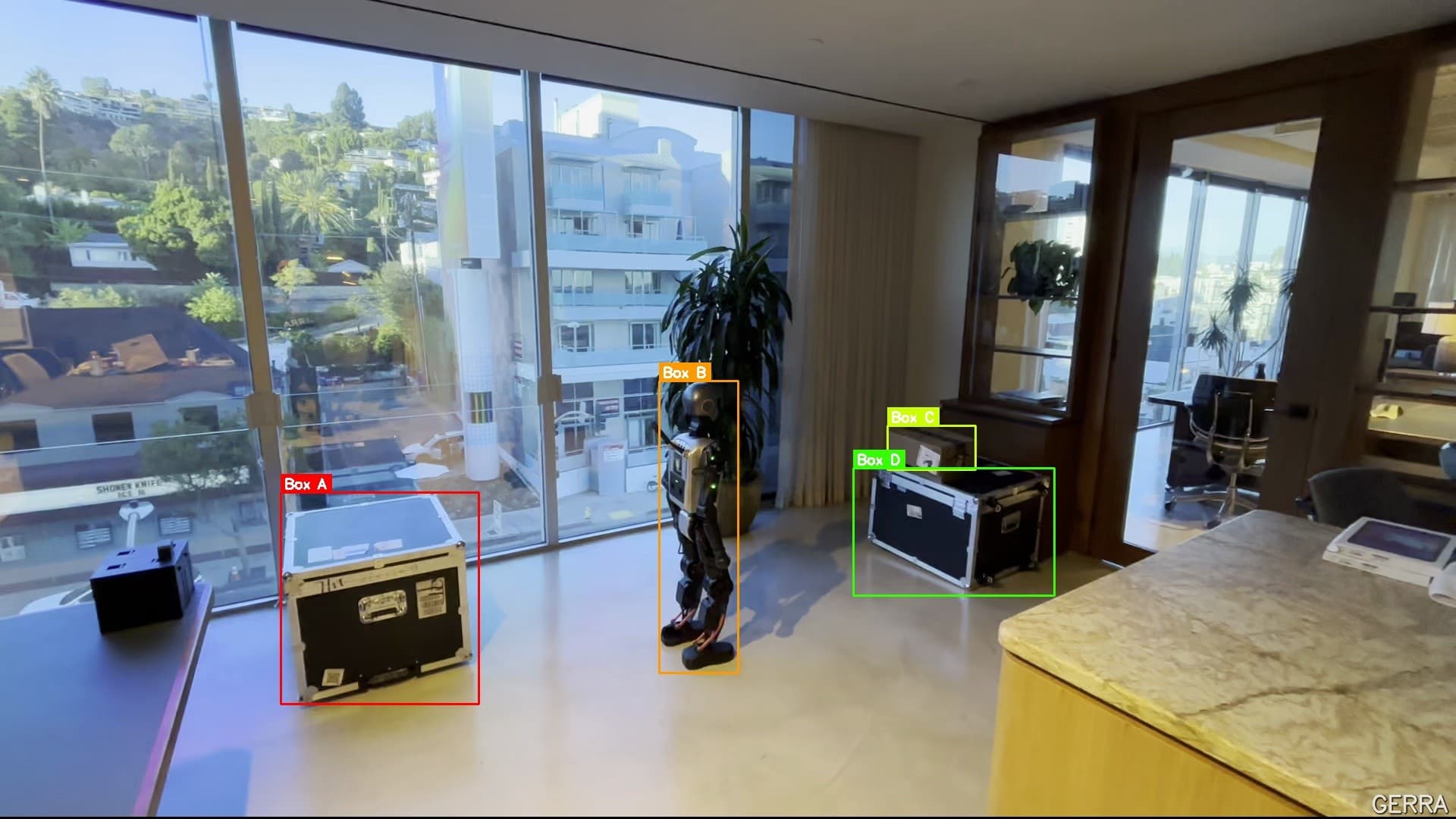 Humanoid robot beside labeled flight cases in the box-handling recording